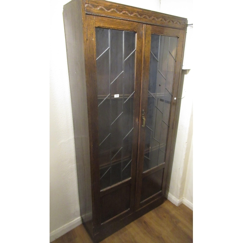 1556 - Art Deco oak bookcase with pair of leaded glazed doors enclosing adjustable shelves, 91 x 31 x 192cm... 