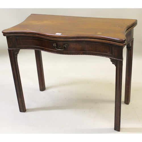 1560 - George III mahogany serpentine shaped fold-over card table, raised on square moulded supports