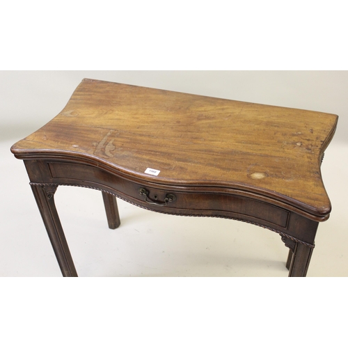 1560 - George III mahogany serpentine shaped fold-over card table, raised on square moulded supports