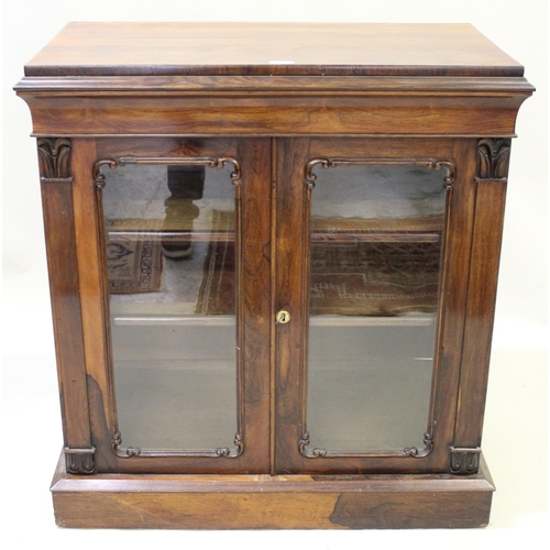 1566 - 19th Century rosewood side cabinet, the moulded top above a pair of glazed panel doors enclosing she... 