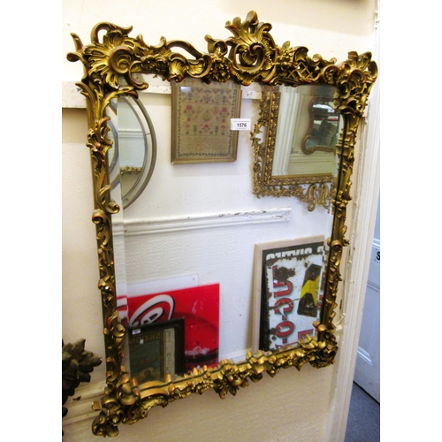 Ornate gilded composition wall mirror with bevelled plate, 83cm high