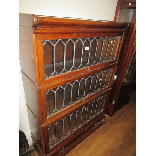 1582 - Oak three section Globe Wernicke bookcase having leaded glazed doors, the base with single drawer, 1... 