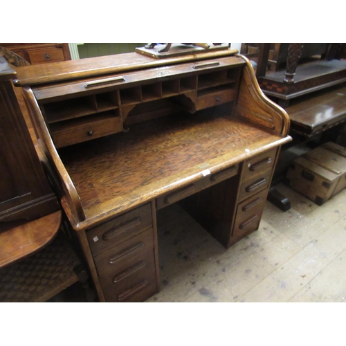 1602 - 20th Century tambour fronted pedestal desk having a fitted interior above an arrangement of seven dr... 