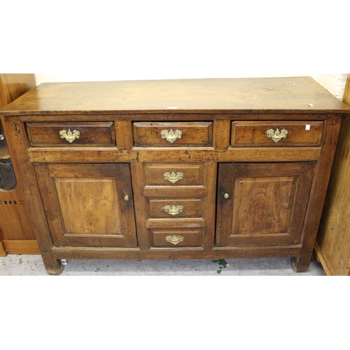 1616 - George III oak and fruitwood dresser base, the plank top above three drawers, two fielded panel door... 