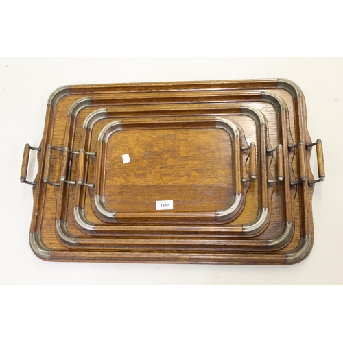 1617 - Set of four early 20th Century oak metal mounted two handled graduated trays from 71cm wide x 47cm t... 