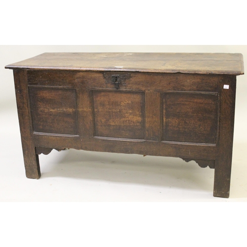 1632 - Small 17th Century oak coffer, the hinged moulded plank lid above a three panel front on stile suppo... 