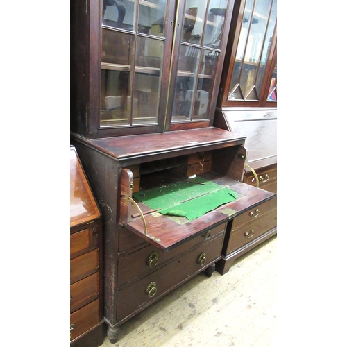 1642B - Regency mahogany secretaire bookcase, the shaped pediment above a pair of bar glazed doors enclosing... 