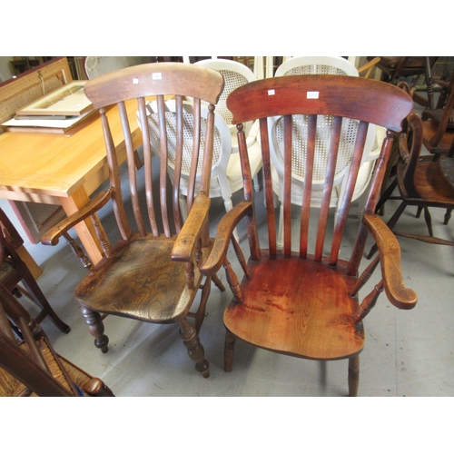 1647 - Two early 20th Century stick back oak and elm kitchen elbow chairs on turned supports