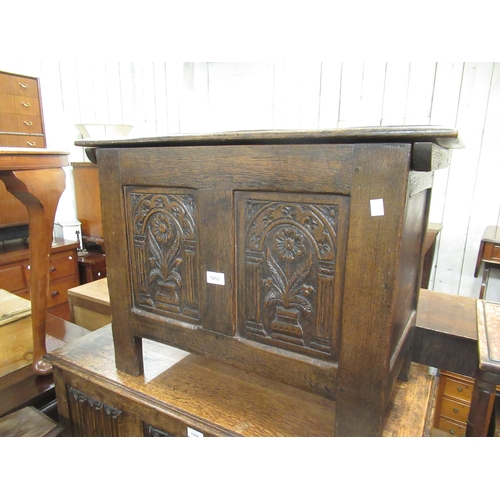 1653 - 20th Century oak coffer, the hinged cover above a two panel front with carved decoration on stile su... 