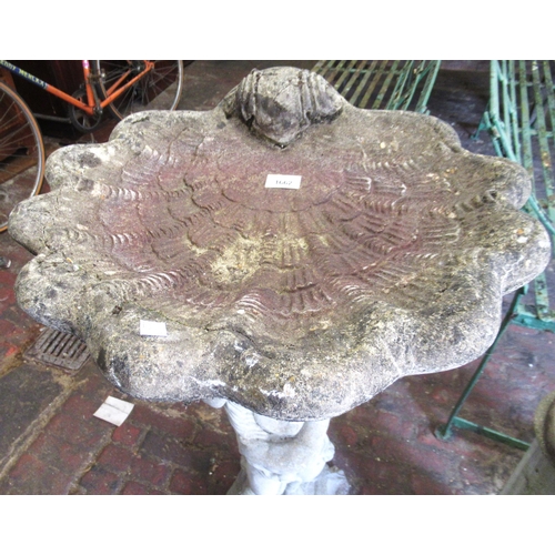 1662 - Late 20th Century weathered cast concrete shell form bird bath with putti support, 96cm high