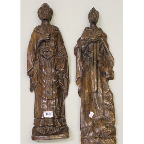 1686 - Two Continental carved wooden wall plaques in the form of Saints, each 60cm high