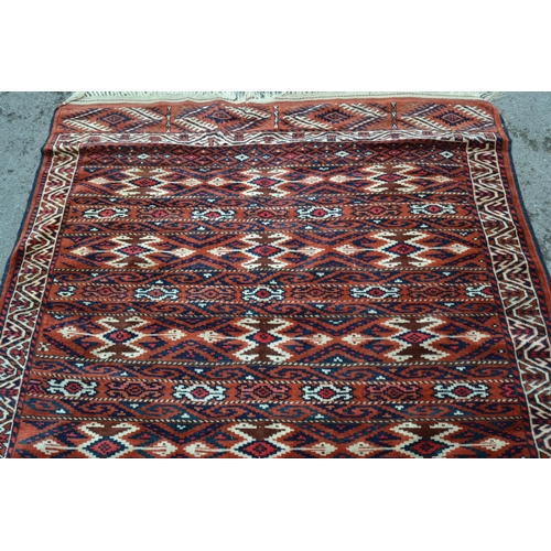 23 - Turkoman rug with an unusual banded design in shades of madder cream and blue, 216 x 155cm