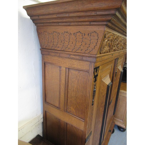 1698 - Dutch panelled oak linen cupboard, the cornice carved with cherubs and birds amongst foliage, over t... 