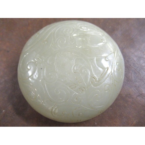 127 - Small 20th Century carved pale green jade circular box and cover, decorated in shallow relief, 8.5cm... 