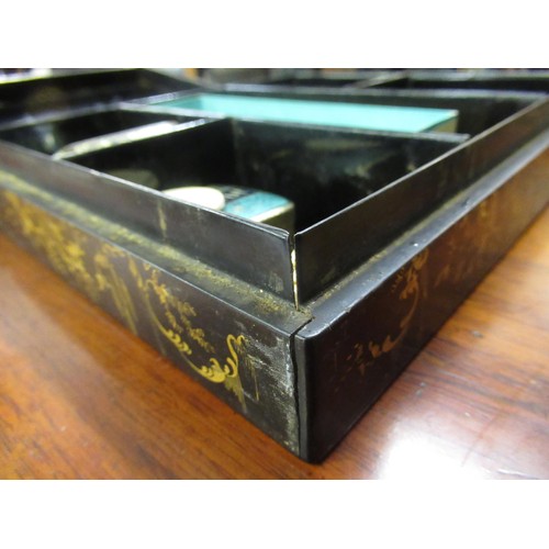 286 - 19th Century black lacquered mother of pearl inset and floral painted games box containing a quantit... 