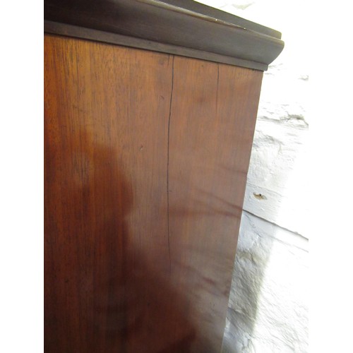 1492 - Small 19th Century mahogany linen press with two panelled doors enclosing shelves, above six small d... 