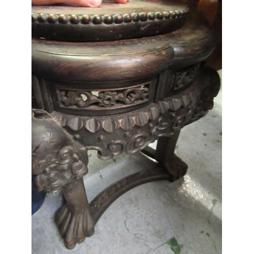 1577 - Chinese circular hardwood marble inset jardinere stand carved with maskheads, 15cm diameter, 47cm hi... 