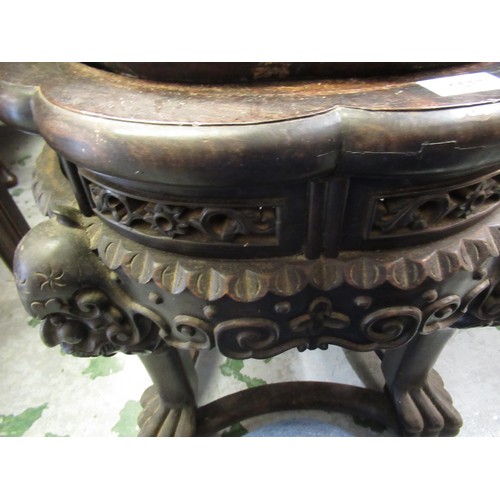 1577 - Chinese circular hardwood marble inset jardinere stand carved with maskheads, 15cm diameter, 47cm hi... 