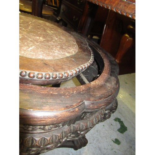 1577 - Chinese circular hardwood marble inset jardinere stand carved with maskheads, 15cm diameter, 47cm hi... 