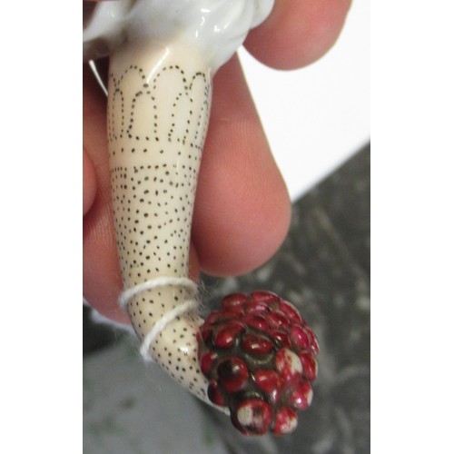 353 - Antique porcelain gilt metal mounted needle case in the form of a lady's arm holding grapes