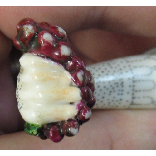 353 - Antique porcelain gilt metal mounted needle case in the form of a lady's arm holding grapes