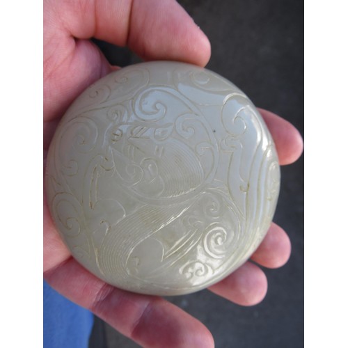 127 - Small 20th Century carved pale green jade circular box and cover, decorated in shallow relief, 8.5cm... 