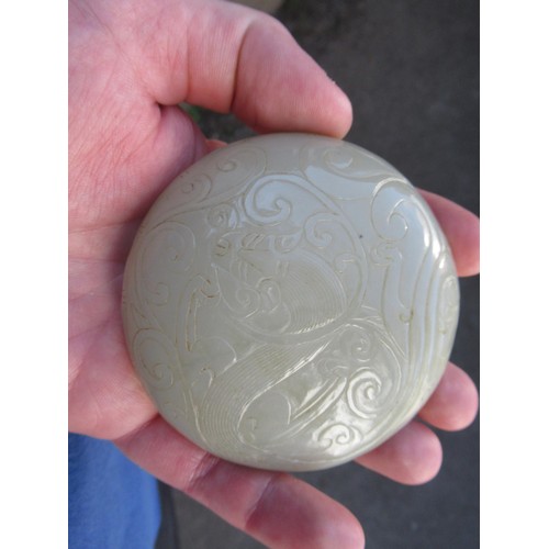 127 - Small 20th Century carved pale green jade circular box and cover, decorated in shallow relief, 8.5cm... 