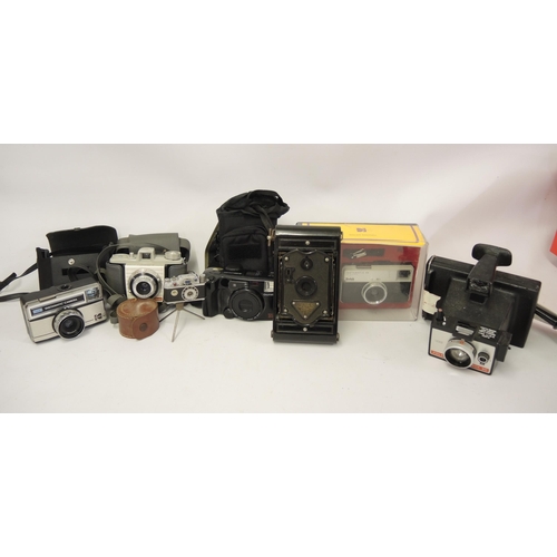 122 - Small collection of various cameras, pair of oak barley twist candlesticks and a small African carve... 