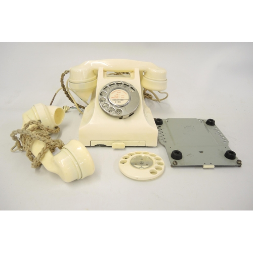 123 - Mid 20th Century cream Bakelite telephone, together with a small quantity of related parts