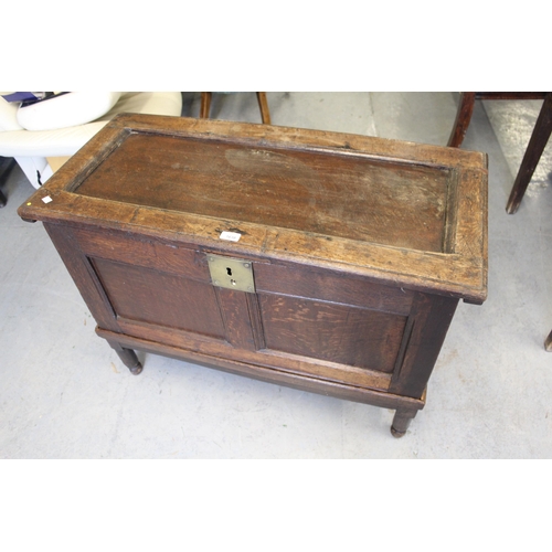 1638 - Small oak coffer on stand, the hinged single panel top above a two panel front on a replacement base... 