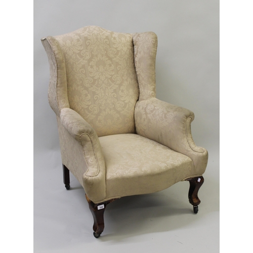 1646 - Early 20th Century upholstered wing armchair in Georgian style on mahogany cabriole supports