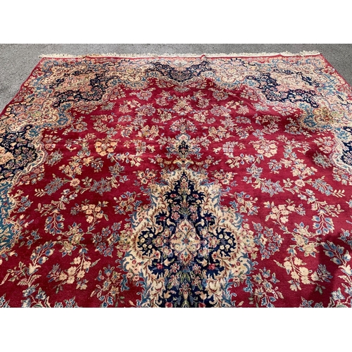 2 - Kirman carpet with a central lobed medallion and all-over stylised floral design, on a rose pink gro... 