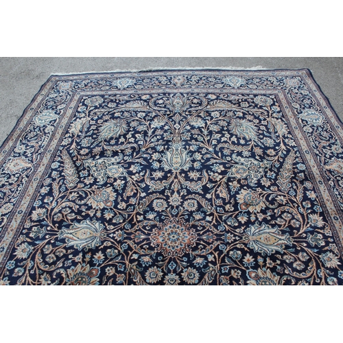 22 - Indo Persian carpet with an all-over palmette and floral design on a midnight blue ground with borde... 