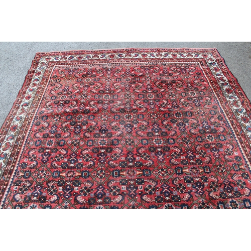 25 - Hamadan carpet with all-over Herati design on a red ground with borders, 310 x 215cm (slight wear)