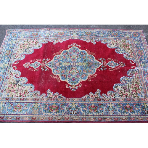 28 - Pair of Indian rugs with a lobed medallion design on a wine ground with borders, 223 x 143cm each