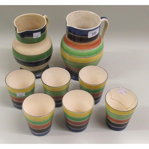 Ashtead pottery seven piece lemonade set (cup and jug at fault), together with another similar jug