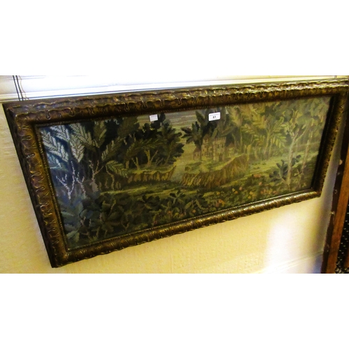 61 - Early 20th Century woolwork picture, a castle in a landscape, housed in an ornate gilt frame, 37 x 9... 