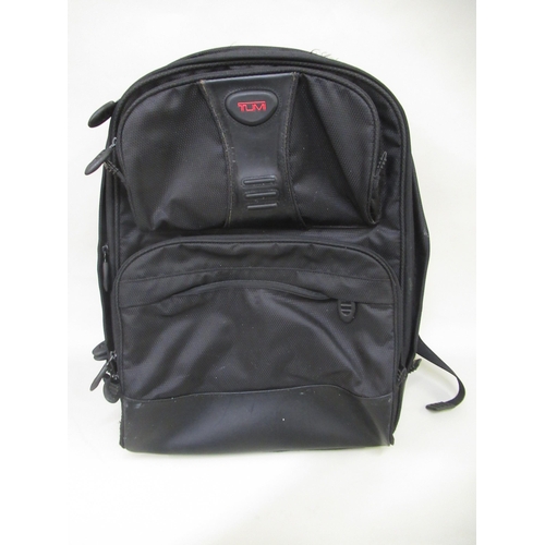 67 - Tumi, black backpack (split to handle)