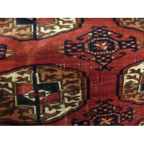 8 - Tekke rug with three rows of nine gols on a wine ground with borders, 206 x 143cm approximately