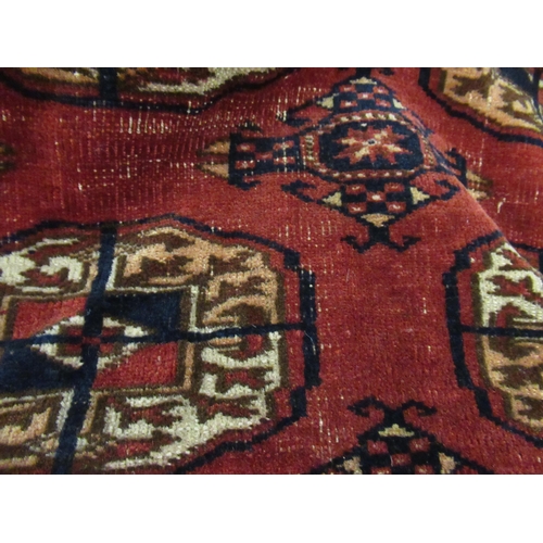 8 - Tekke rug with three rows of nine gols on a wine ground with borders, 206 x 143cm approximately