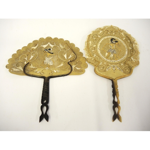 81 - Two Indonesian pierced and hand painted vellum face screens / fans with horn handles, decorated with... 