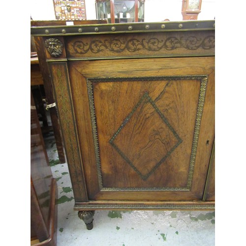 1624 - Pair of Regency rosewood and cut brass inlaid two door side cabinets, each with a brassbound and cro... 