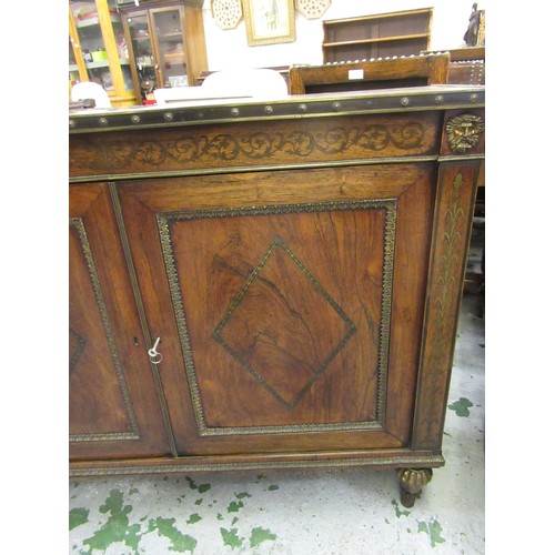 1624 - Pair of Regency rosewood and cut brass inlaid two door side cabinets, each with a brassbound and cro... 