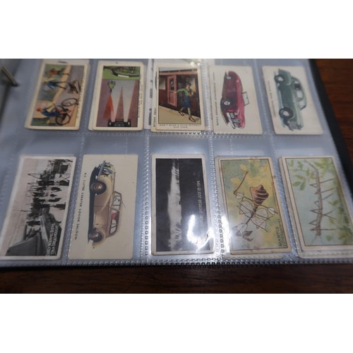 254 - Two albums containing a collection of various scarce cigarette cards in mixed condition and an album... 