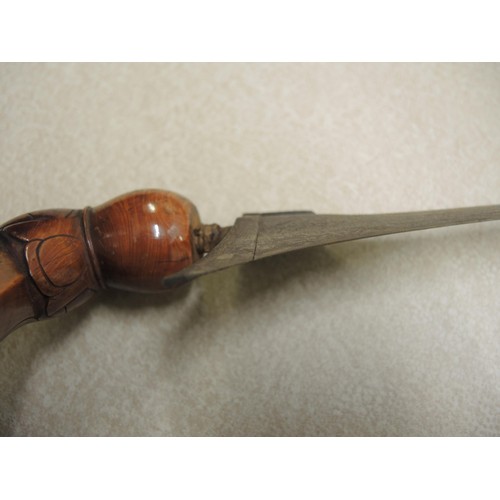 211 - Indonesian hardwood handled kris with wooden sheath, together with another bone handled and brass mo... 