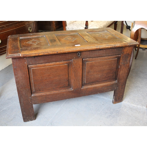 17th Century oak coffer, the hinged three panel lid above a two panel front on stile supports, 105cms wide