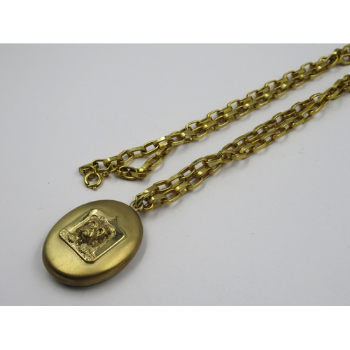 Antique pinchbeck oval locket decorated with a figure of a Scottie dog, on a gold plated chain link necklace