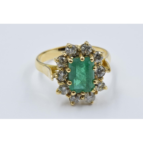 1038 - 18ct Yellow gold rectangular emerald and diamond cluster ring, the emerald approximately 10mm x 6mm,... 