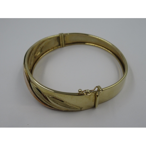 1055 - 9ct Three colour gold bangle, 15g