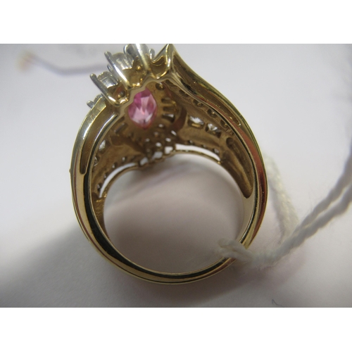 1063 - 10ct Yellow gold dress ring set pink centre stone flanked by white stones, size N, 7.8g